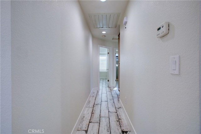 hallway with hardwood / wood-style flooring