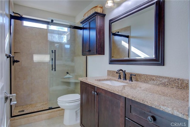 bathroom featuring vanity, toilet, tile patterned floors, and walk in shower