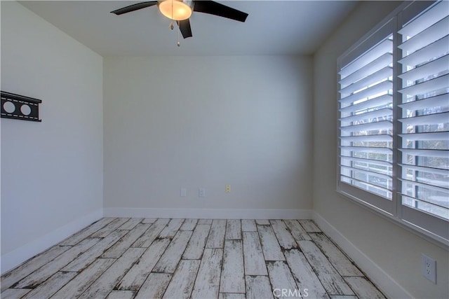 empty room with ceiling fan, light hardwood / wood-style floors, and a healthy amount of sunlight