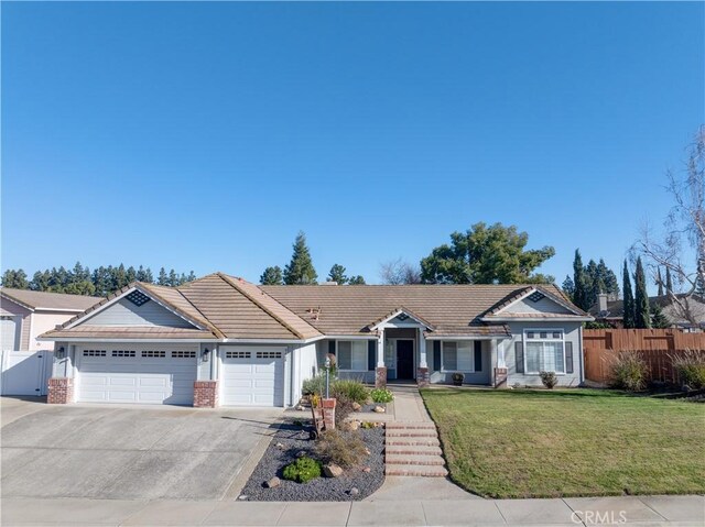 single story home featuring a garage and a front yard