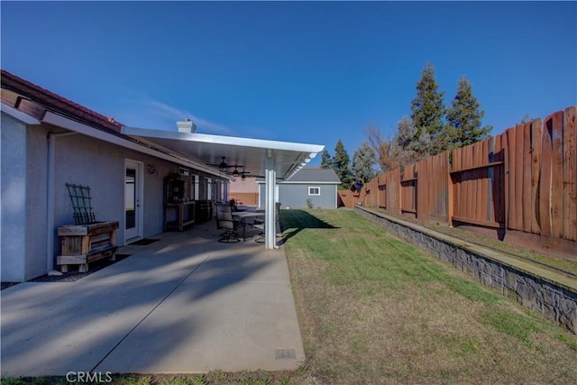 view of yard featuring a patio and ceiling fan