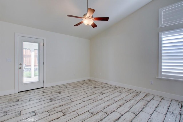 empty room featuring ceiling fan, lofted ceiling, and light wood-type flooring