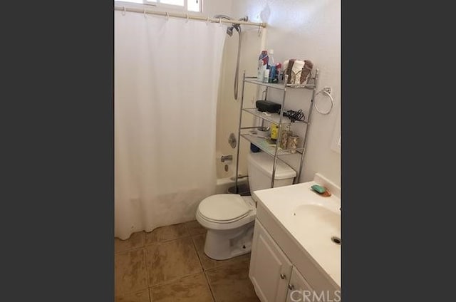 full bathroom featuring vanity, shower / bath combo, tile patterned floors, and toilet