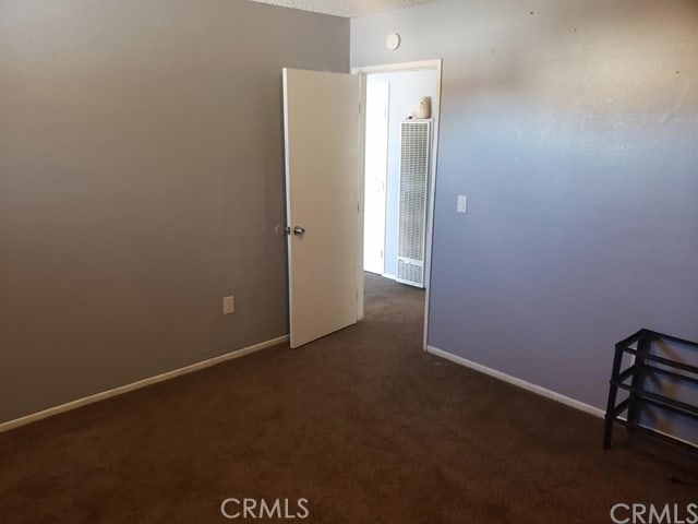 carpeted spare room with a textured ceiling