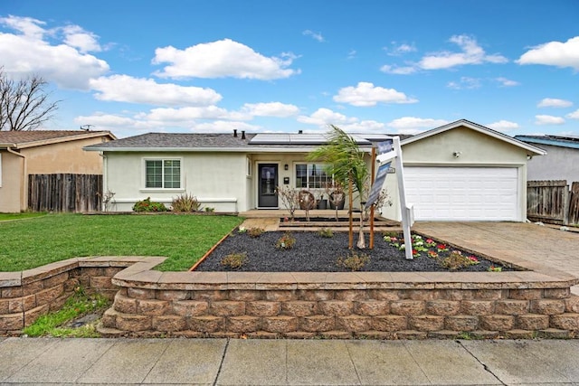 ranch-style home with a garage, a front yard, and solar panels