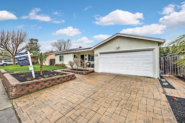 ranch-style home featuring a garage