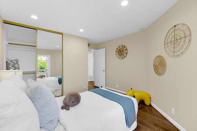 bedroom featuring dark hardwood / wood-style flooring and a closet