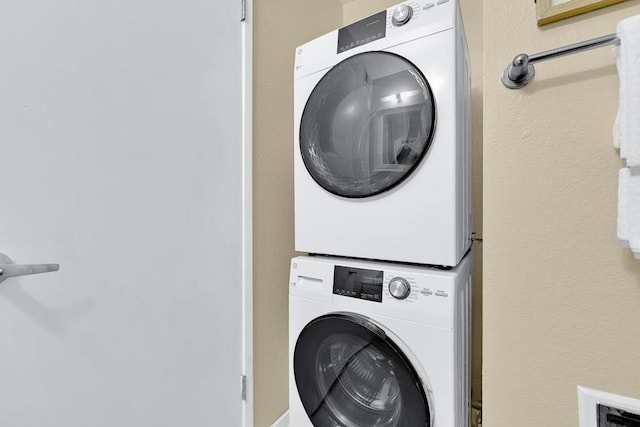 laundry room featuring stacked washing maching and dryer