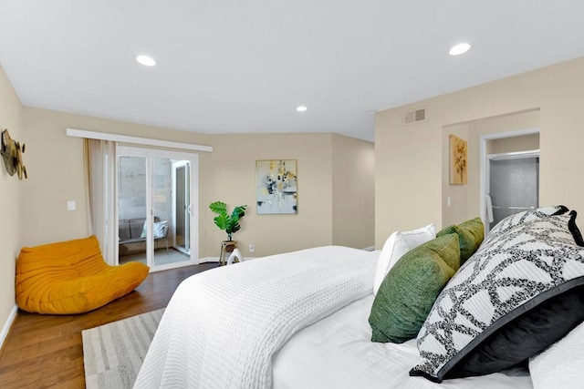 bedroom featuring wood-type flooring and access to outside