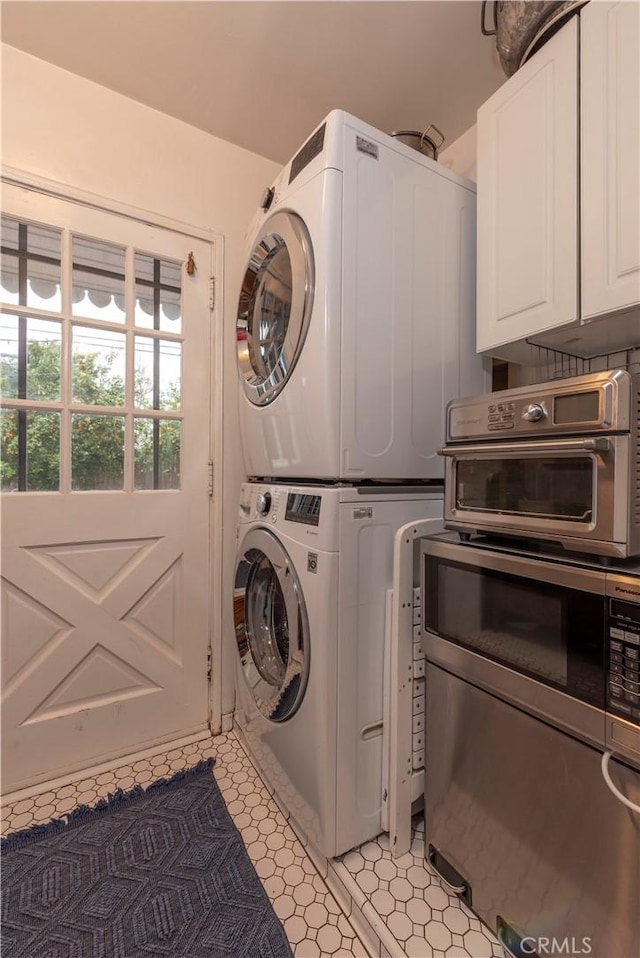 washroom featuring stacked washer and dryer