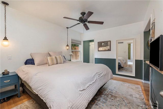 bedroom with hardwood / wood-style flooring and ceiling fan