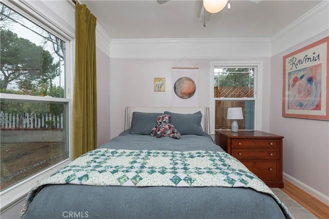 bedroom featuring crown molding, ceiling fan, and hardwood / wood-style floors