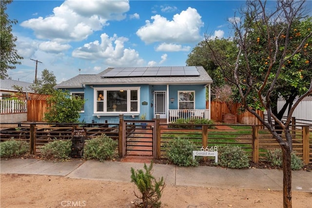 bungalow with covered porch and solar panels