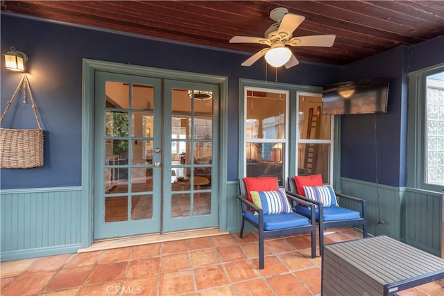 unfurnished sunroom featuring wooden ceiling, french doors, and ceiling fan