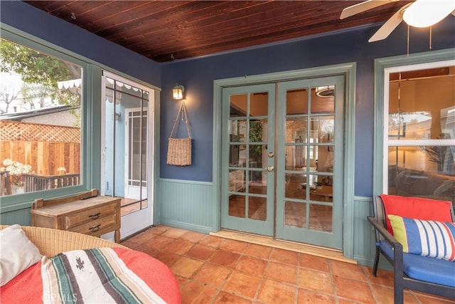 sunroom with wood ceiling, french doors, and ceiling fan