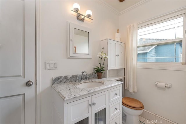 bathroom with crown molding, vanity, and toilet