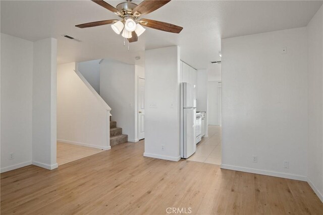 unfurnished living room with ceiling fan and light wood-type flooring