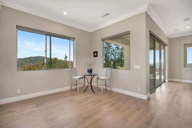 unfurnished room with light wood finished floors, visible vents, and a healthy amount of sunlight