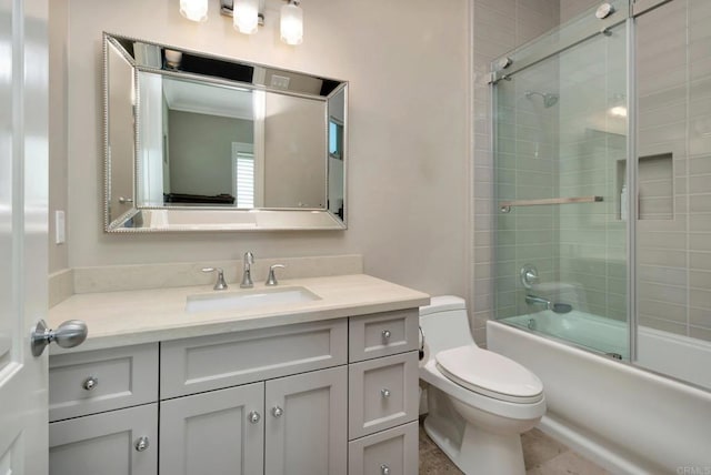 bathroom with toilet, combined bath / shower with glass door, and vanity