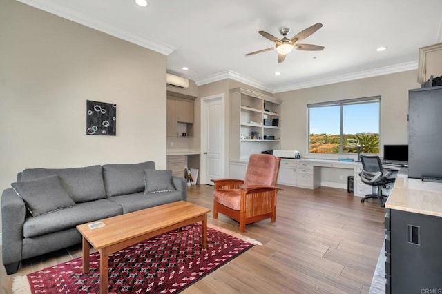 living area with crown molding, built in desk, light wood finished floors, a wall mounted AC, and ceiling fan