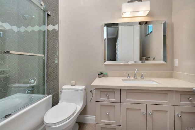 bathroom featuring vanity, toilet, and bath / shower combo with glass door