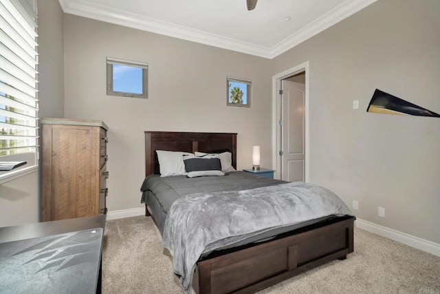 bedroom featuring light carpet, ceiling fan, baseboards, and crown molding