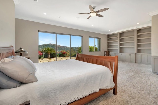 bedroom featuring a mountain view, recessed lighting, light colored carpet, access to exterior, and crown molding