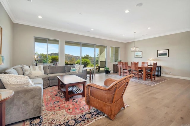 living room with ornamental molding, recessed lighting, baseboards, and light wood finished floors