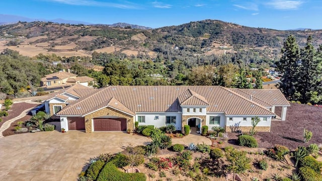 3026 Via Loma, Fallbrook, CA 92028 - view of front of home with a tiled roof, a garage, stucco siding, concrete driveway, and stone siding