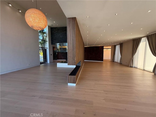 interior space with a high ceiling and light wood-type flooring