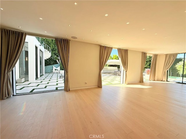 unfurnished room with light hardwood / wood-style floors