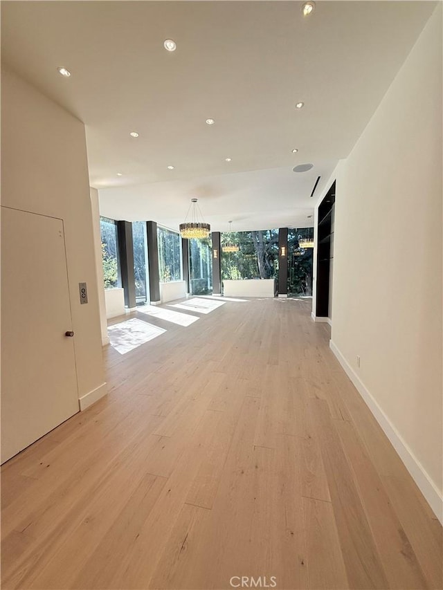 hallway featuring expansive windows and light wood-type flooring