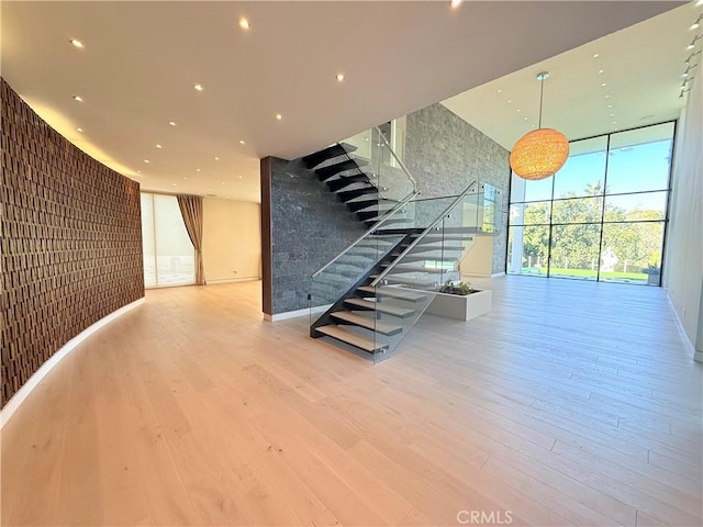 interior space featuring a wall of windows and wood-type flooring