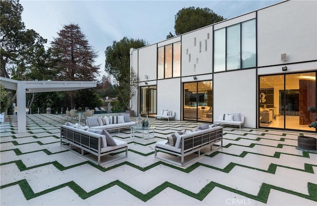 exterior space with an outdoor hangout area and a patio area