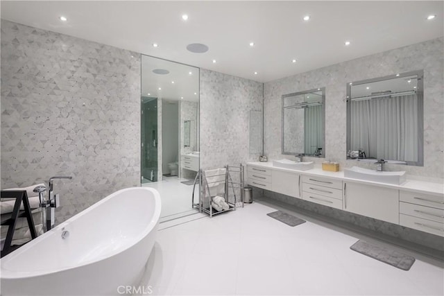 bathroom featuring vanity, toilet, and a tub