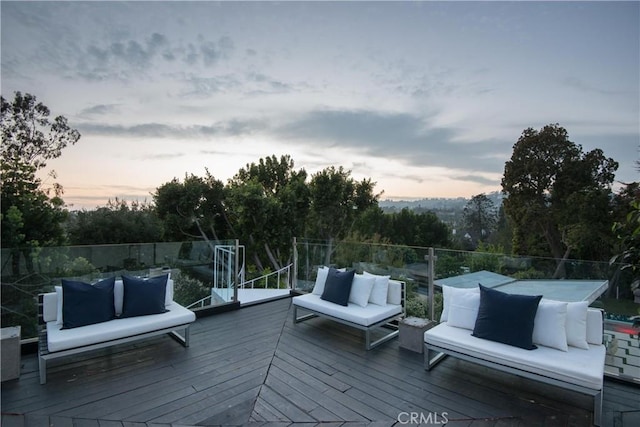 deck at dusk featuring outdoor lounge area