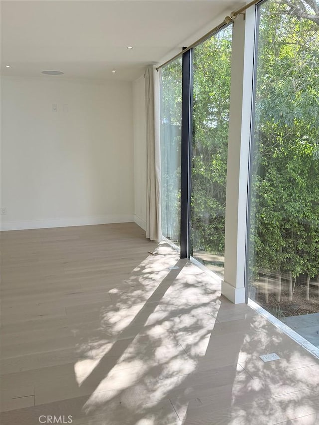 unfurnished room featuring floor to ceiling windows