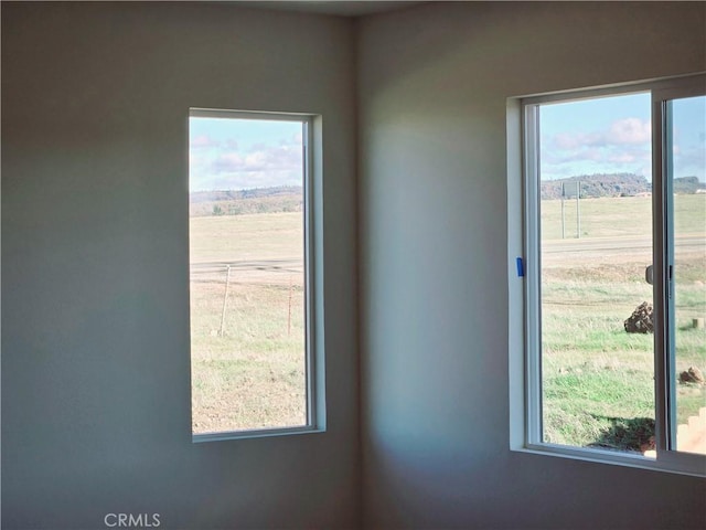 unfurnished room with a rural view