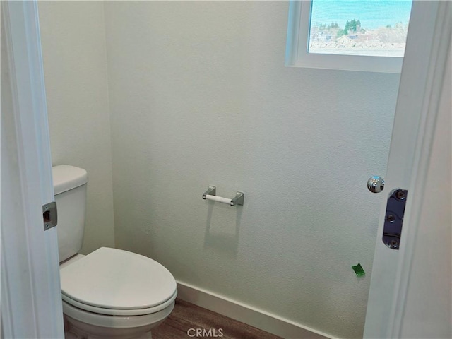 bathroom featuring hardwood / wood-style floors and toilet