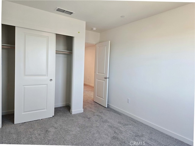 unfurnished bedroom with a closet and carpet