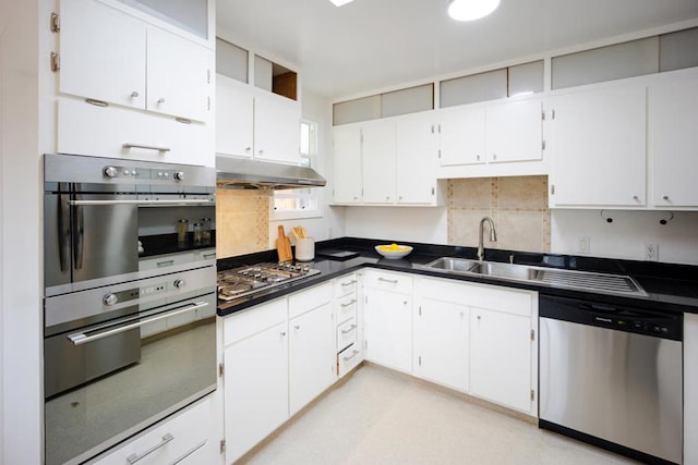 kitchen featuring white cabinetry, appliances with stainless steel finishes, sink, and decorative backsplash