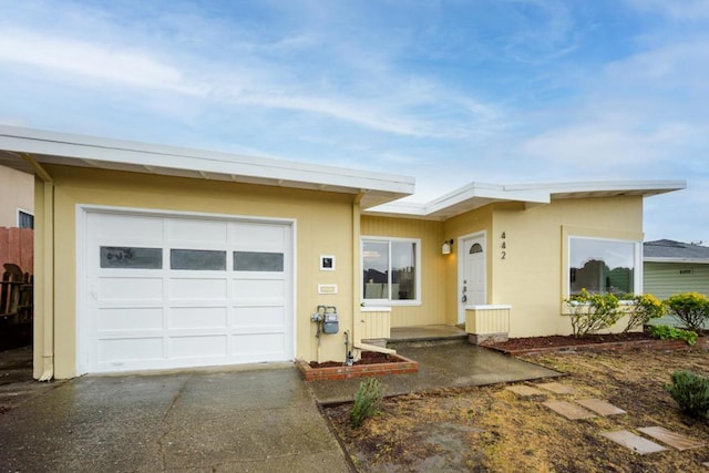 ranch-style home featuring a garage