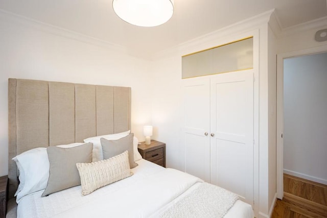 bedroom featuring ornamental molding and a closet