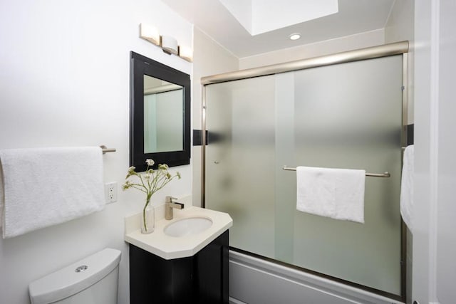 full bathroom with vanity, combined bath / shower with glass door, and toilet