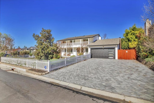 view of front of property with a garage and a balcony