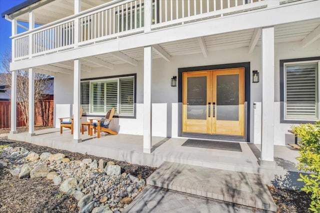 doorway to property with a patio, a balcony, and french doors