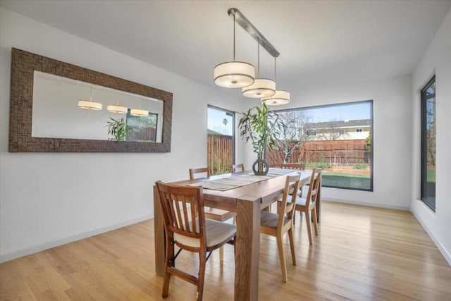 dining space with light hardwood / wood-style floors