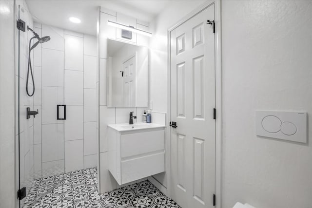 bathroom featuring vanity and a shower with door