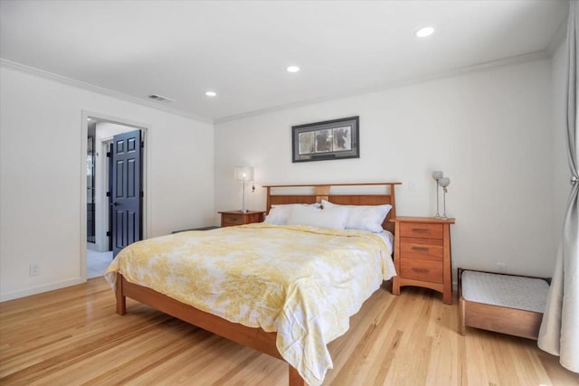 bedroom featuring crown molding and light hardwood / wood-style flooring