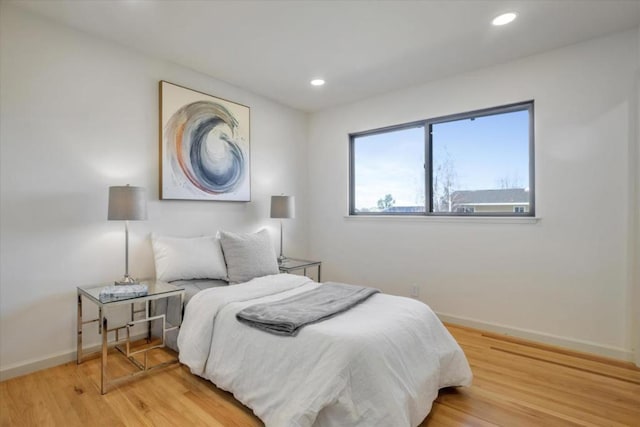 bedroom with hardwood / wood-style floors